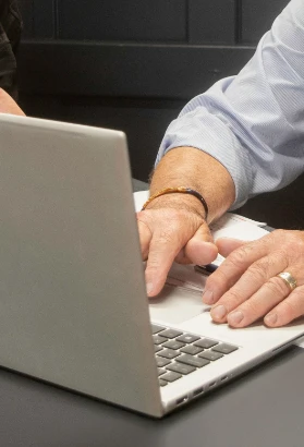 Close up of man typing on laptop keyboard